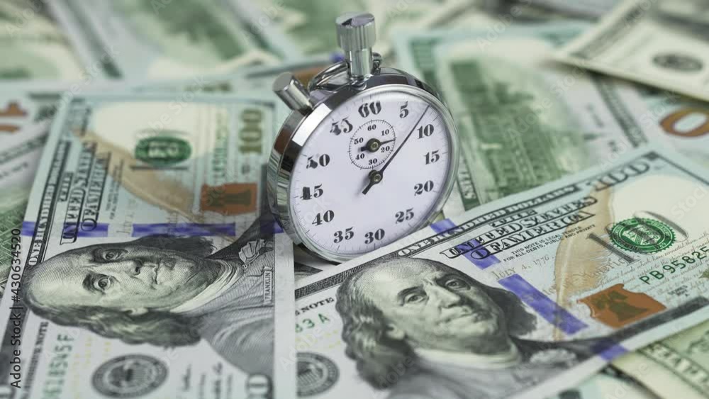 Time is money. The stopwatch is set against the backdrop of many American dollars in cash. The concept of saving time, business, finance, lost time.
Time is money. The stopwatch is set against the backdrop of many American dollars in cash. The concept of saving time, business, finance, lost time.