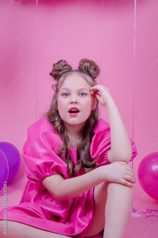 attractive brunette girl model with pink make up and in pink leather dress near colorful balloons on pink background.concept of joy, party, birthday. attractive brunette girl model with pink make up and in pink leather dress near colorful balloons on pink background.concept of joy, party, birthday.