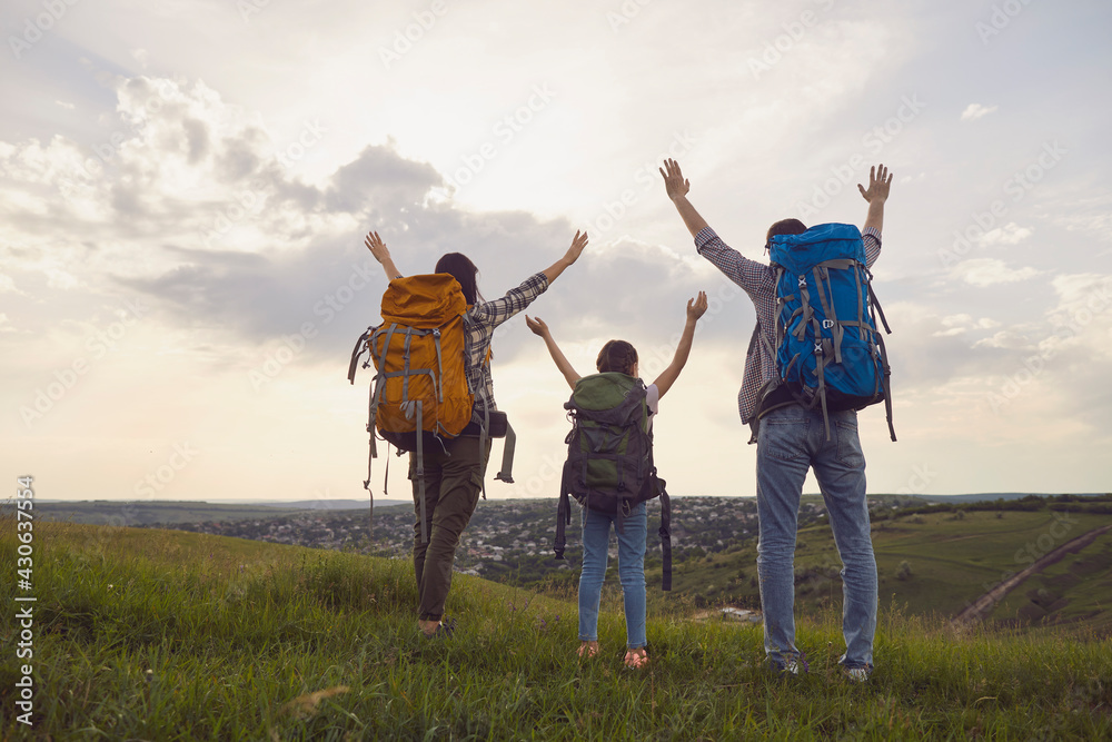 Happy family with backpacks on the nature at sunset. Hiking family tourism concept. Happy family with backpacks on the nature at sunset. Hiking family tourism concept.