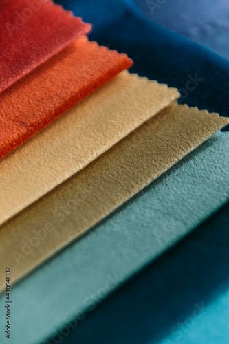 Collection of colorful velour textile samples. Fabric designed for sofas and armchairs. Fabric texture background