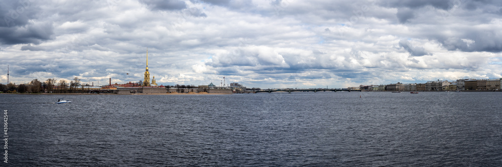 Amazing Panorama of St. Petersburg, the famous city in Russia. Cloudy spring day. On the horizon is spire of the Peter and Paul Fortress on grey clouds background. View from 