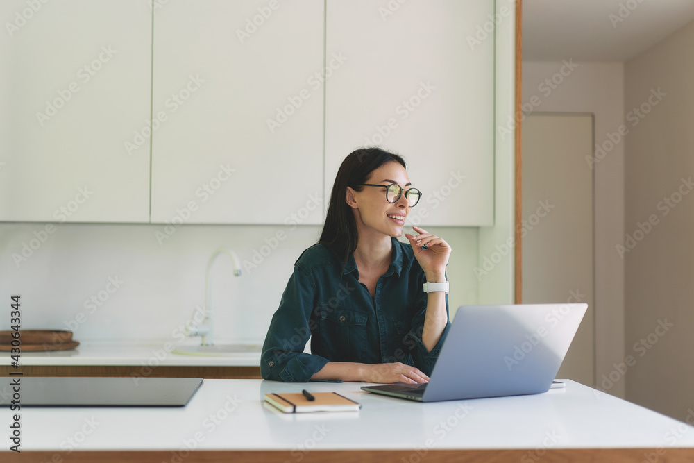 Front view of business woman working from home with laptop and notebook Front view of business woman working from home with laptop and notebook