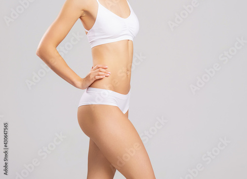 Woman in swimsuit. Close-up of a beautiful and fit female figure. Health, body care, sports and diet concept.