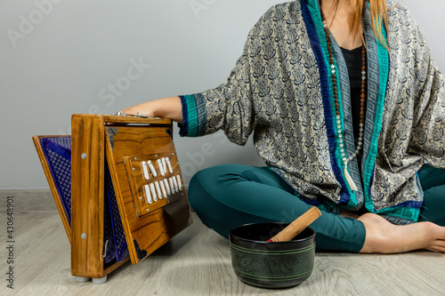 Shruti, a musical instrument of Indian origin. Indian harmonium. Woman performing kirtan, chanting mantras. photo