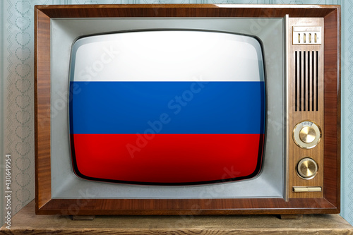 old tube vintage TV with the national flag of Russia on the screen, the concept of eternal values ​​on television, global world trade, politics, retro technologies, news