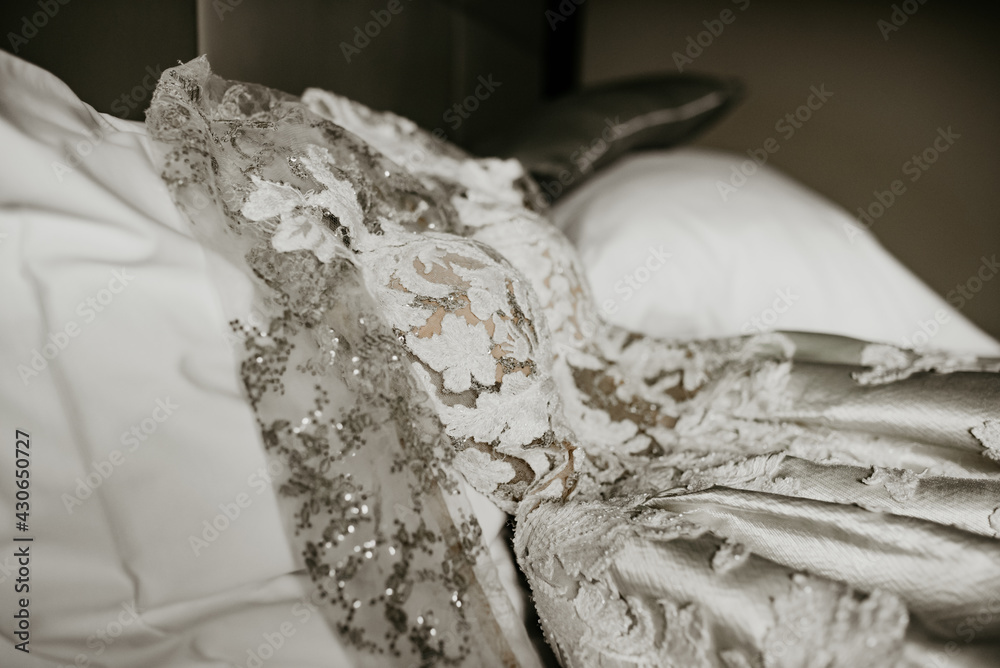 bride zipping buttoning her white wedding dress bride zipping buttoning her white wedding dress