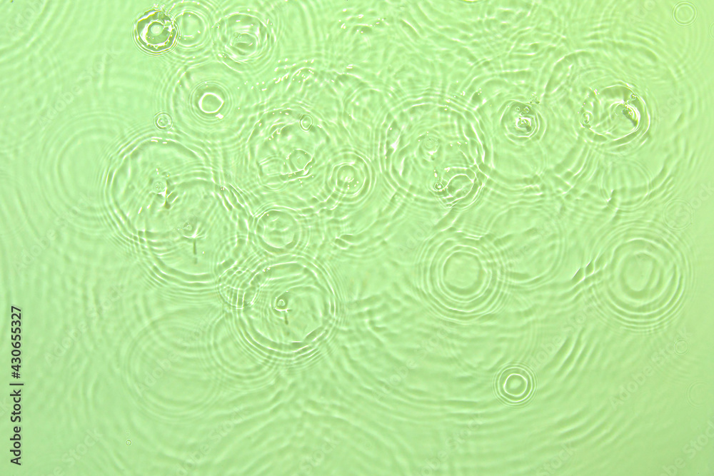 De-focused closeup of mint green transparent clear water surface texture with ripples, splashes and bubbles. Trendy abstract summer nature background. Mint colored waves in sunlight with copy space. De-focused closeup of mint green transparent clear water surface texture with ripples, splashes and bubbles. Trendy abstract summer nature background. Mint colored waves in sunlight with copy space.