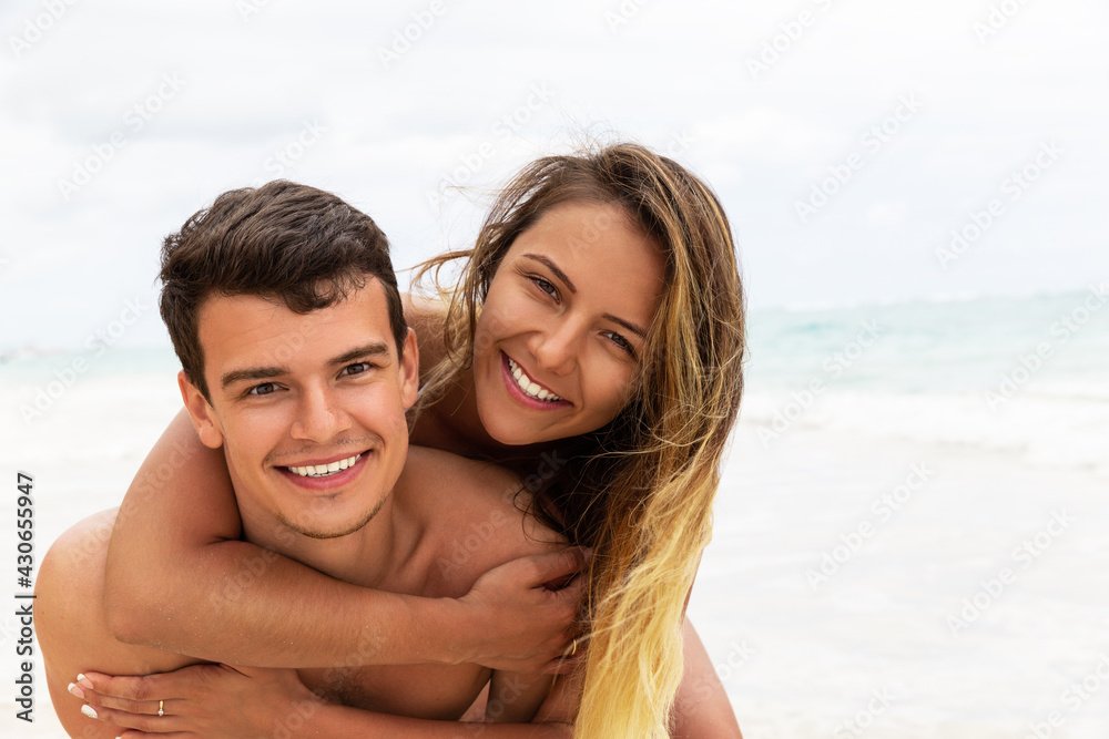 Happy couple in love enjoy summer vacation at beach with copy space.