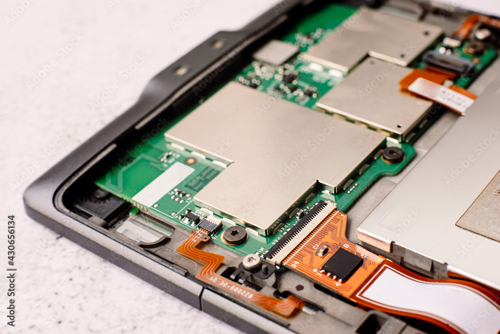 Fototapeta premium Interior of a small electronic device, with motherboard and transistors exposed.