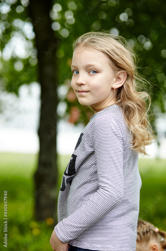 Little girl play in the park. The concept of a happy childhood, summer outdoor recreation, summer vacation Little girl play in the park. The concept of a happy childhood, summer outdoor recreation, summer vacation