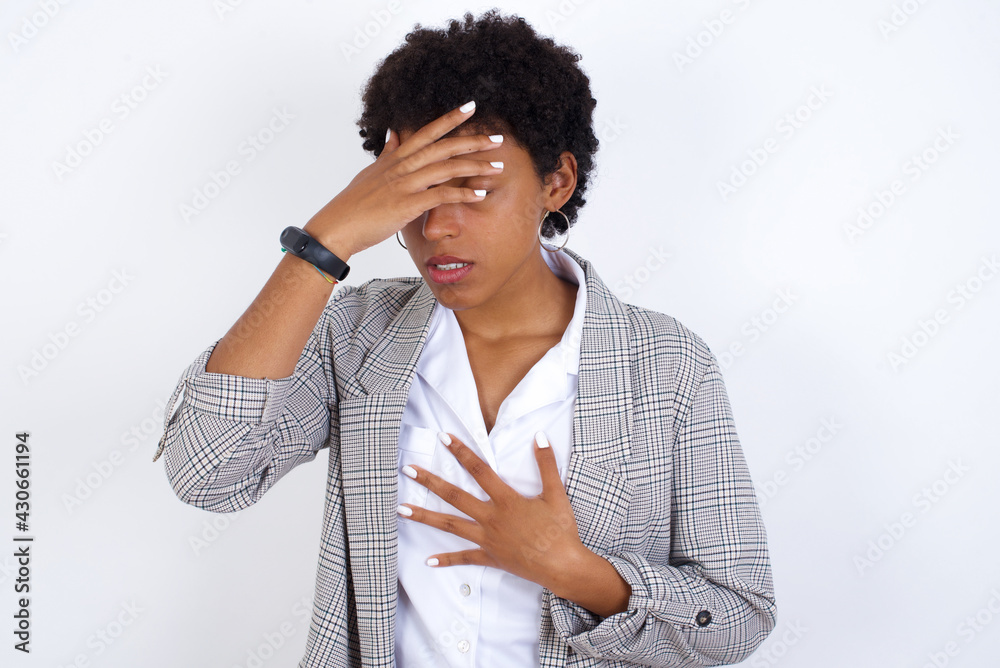 African American businesswoman with curly bushy hair wears  formal clothes over white background Touching forehead for illness and fever, flu and cold, virus sick.