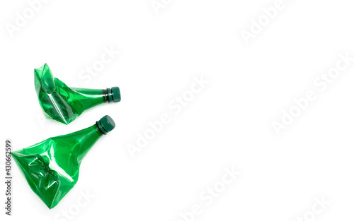 Slika na platnu Empty green plastic water bottles scaled for recycling isolated on white background