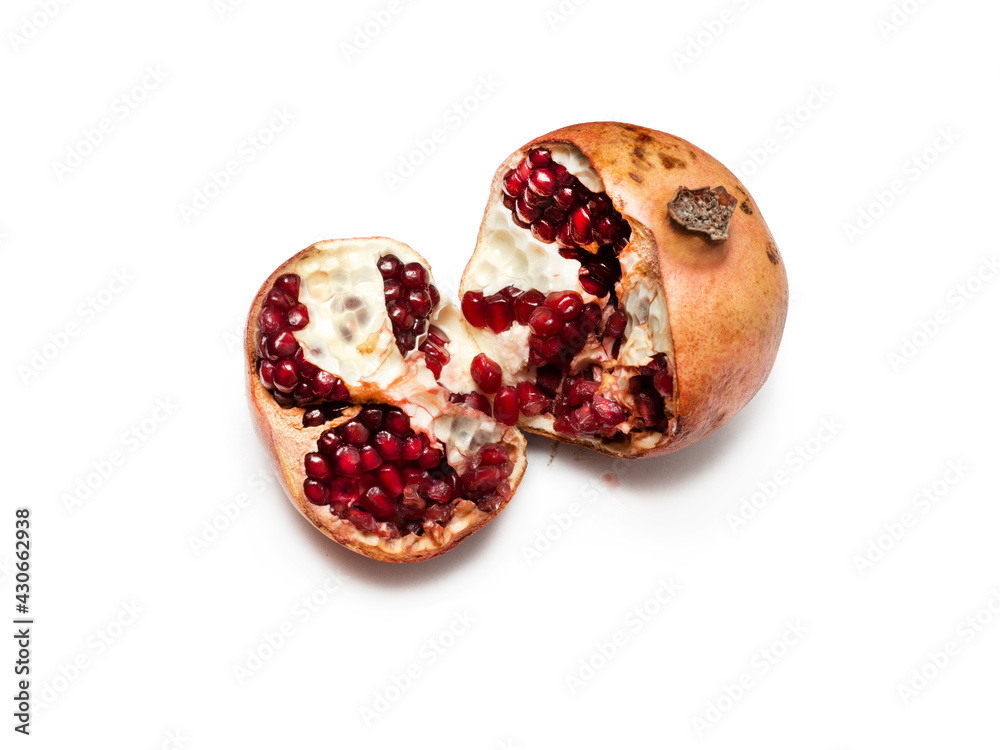 One rotten, half-decomposed, burst, moldy fruit on a white background. Spoiled, unhealthy, open red pomegranate with seeds falling out. Concept of expired food products. Contraband, sanctions goods. One rotten, half-decomposed, burst, moldy fruit on a white background. Spoiled, unhealthy, open red pomegranate with seeds falling out. Concept of expired food products. Contraband, sanctions goods.