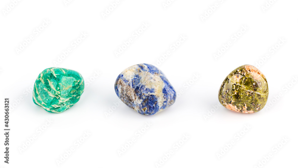 Three different colored gemstones on white background, front view. Lithotherapy, chakra balancing, crystal ritual.