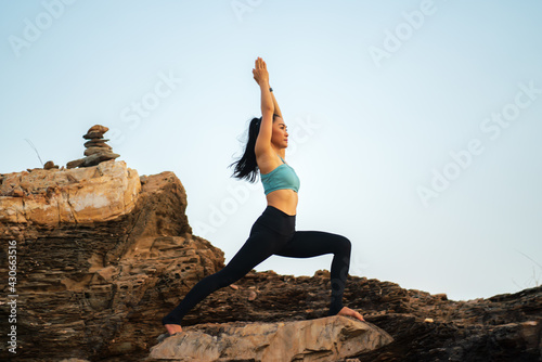 Asian woman practicing yoga on on the mountain . wellness, healthcare, sport and lifestyle 