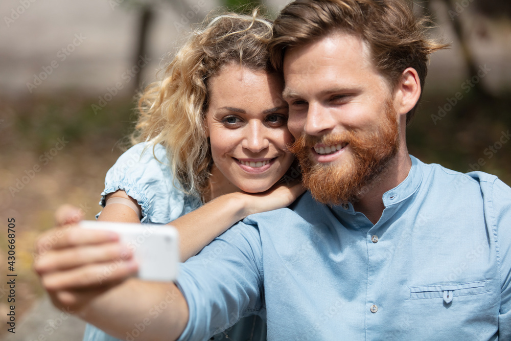 happy hipster couple taking a selfie