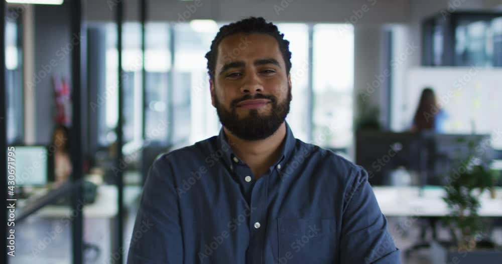 Portrait of mixed race businessman standing in office smiling to camera Portrait of mixed race businessman standing in office smiling to camera
