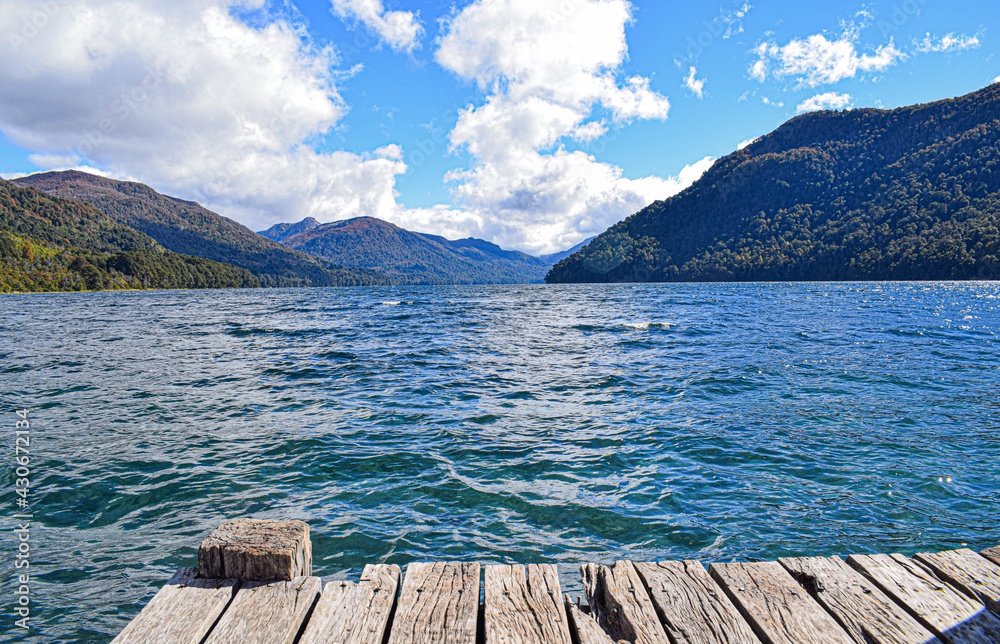 wooden pier on the lake in front of a beautiful mountain