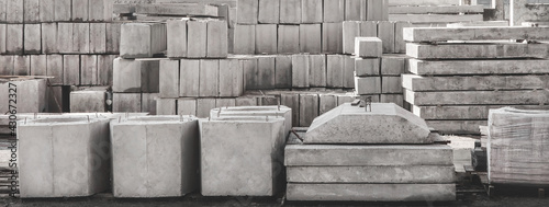 Storage of concrete blocks in a warehouse. Concrete structures at the construction site. Industrial, building cement materials