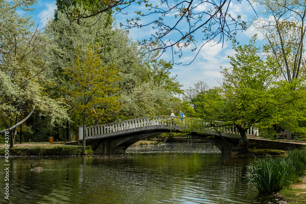 Paris, France 28-04-2021: a bridge over a lake at the ibis park in Vesinet during the spring