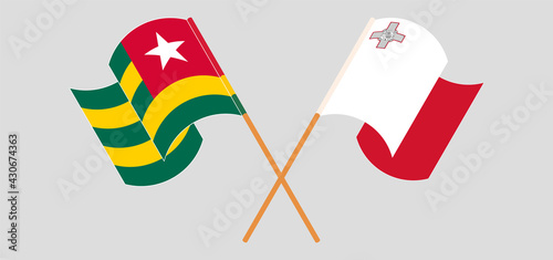 Crossed and waving flags of Togo and Malta
