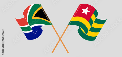 Crossed and waving flags of Republic of South Africa and Togo