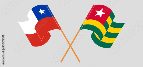 Crossed and waving flags of Chile and Togo
