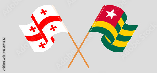 Crossed and waving flags of Georgia and Togo