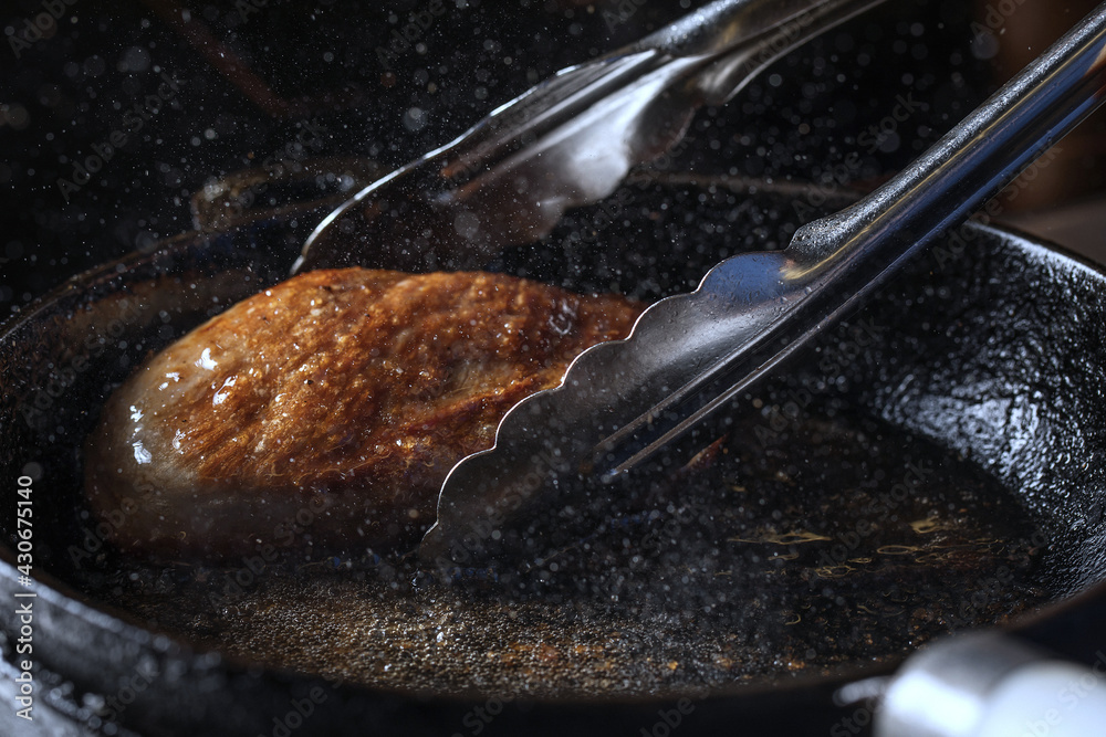 Process of cooking crispy duck breast fillet in iron cast pan Stock