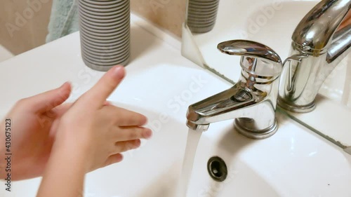 Little girl, school age child washing her hands properly bathroom sink at home, proper technique full sequence, hands closeup, detail Children hygiene and anti viral health care good practices concept