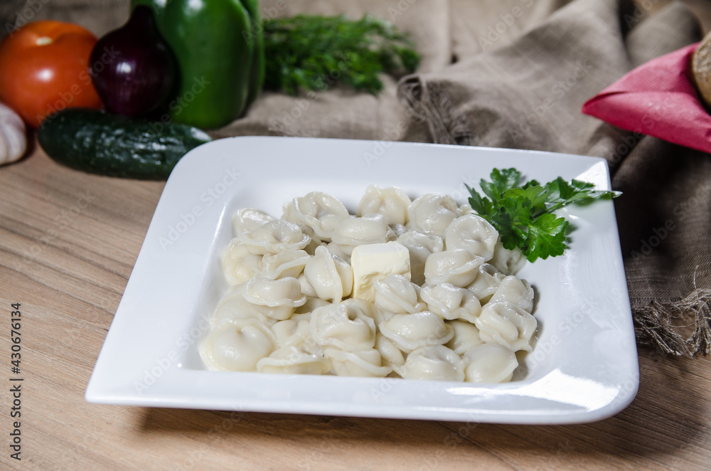 dumplings with meat on white plate. russian pelmeni. dumplings with meat on white plate. russian pelmeni.
