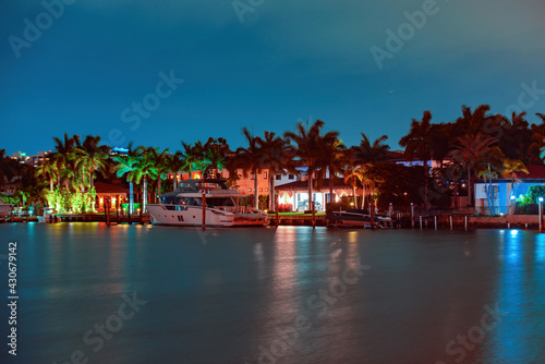 Miami skyscrapers at the night, yacht or boat next to Miami downtown, night view, south beach.