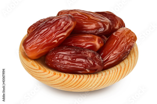 Dates in wooden bowl isolated on white background with clipping path and full depth of field.