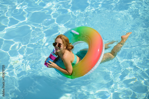 Summertime vacation, summer holiday. Woman on swim ring. Summer mood concept. Pool resort.
