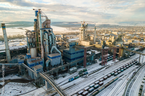 Aerial view of cement plant with high factory structure at industrial production area.
