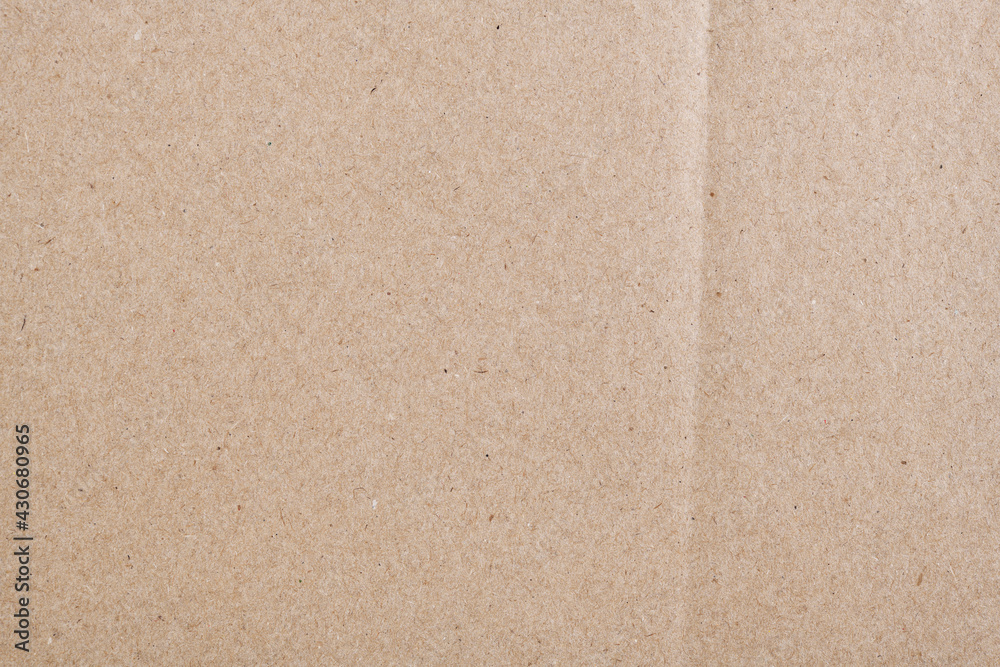 Fototapeta premium Texture of old organic cardboard, beige paper, background for design, copy space. Recyclable material, has inclusions of cellulose