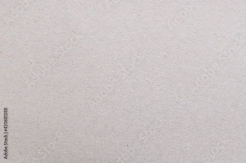 Texture of old organic cardboard, beige paper, background for design, copy space. Recyclable material, has inclusions of cellulose