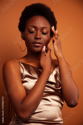 Wallpaper Mural pretty young african american woman with curly hair posing cheerful gesturing on brown background, lifestyle people concept Torontodigital.ca
