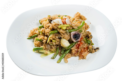 rice with seafood vegetables and garnished with scrapes isolated on white background
