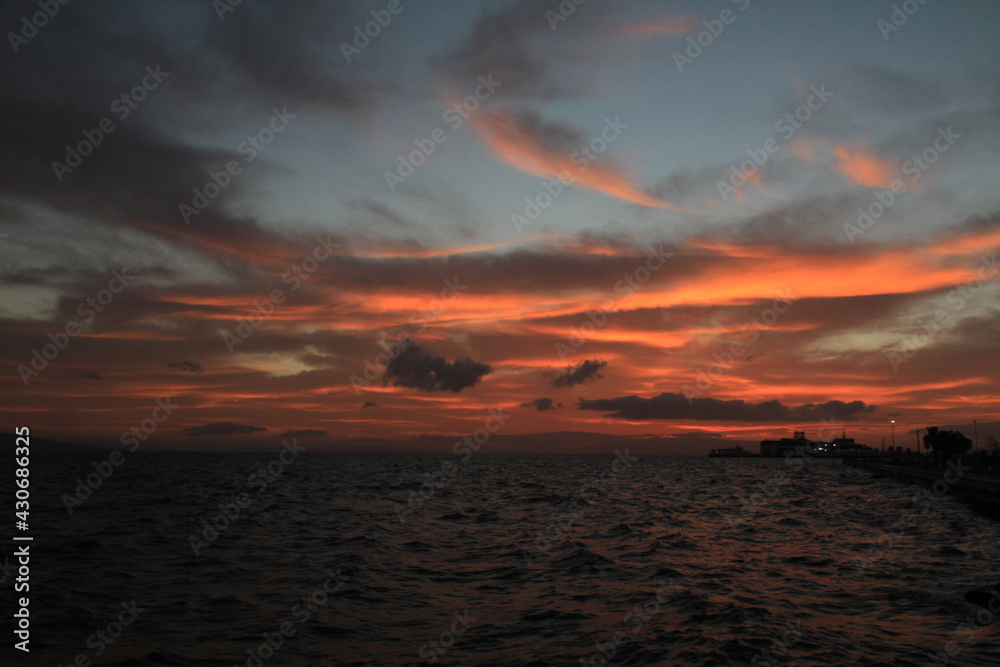 sunset over sea in partly cloudy