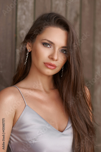 Outdoor portrait of young beautiful pretty caucasian female with long brunette hair. Pretty woman with perfect skin