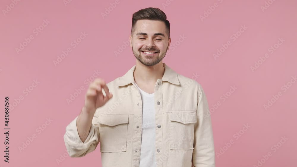 Smiling fun friendly cheerful handsome young man 20s wears light jacket white t-shirt looking camera showing okay ok zero fingers gesture isolated on pastel pink wall color background studio portrait Smiling fun friendly cheerful handsome young man 20s wears light jacket white t-shirt looking camera showing okay ok zero fingers gesture isolated on pastel pink wall color background studio portrait