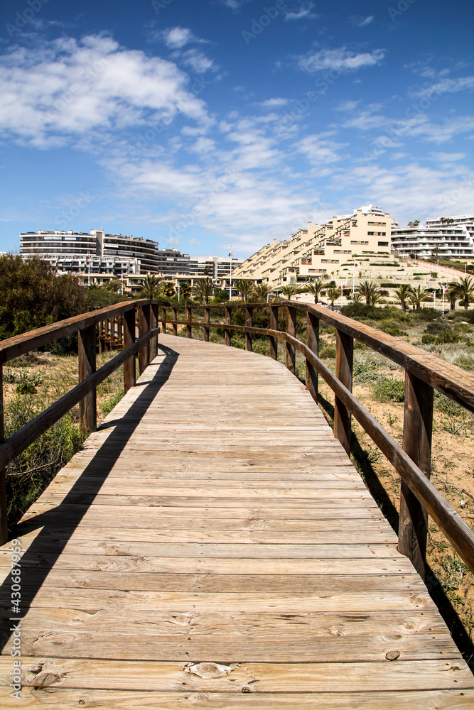 Wooden walkway to the beach in the morning in Spain