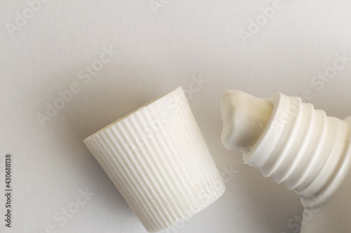 Open white toothpaste canister