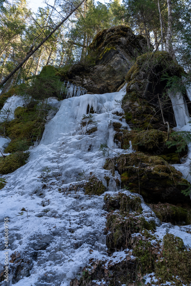 Frozen icicles on rocks in a Norwegian forest in April Frozen icicles on rocks in a Norwegian forest in April