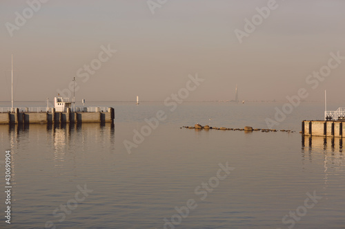 Marine pier for boats and yachts against the backdrop of the sunset. The Gulf of Finland. © AndreyZayats