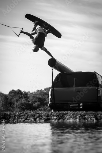 Photography man doing a hand plant on his wakeboard