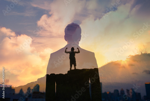 Canvas Print Young strong confident fit man on mountain top facing overcoming his fears