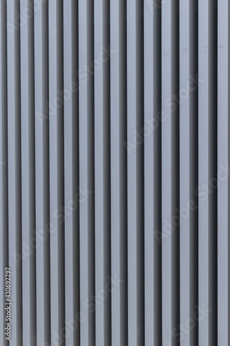 iron structure with straight metal bars forming a striped structure on a wall