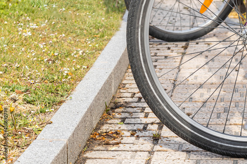 detail of a bicycle wheel rim standing on the street curb